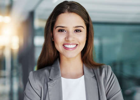 Im ready for corporate success. Cropped portrait of an attractive young businesswoman standing in her office.の写真素材