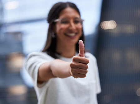 Ive failed over and over, that is why I succeed. Shot of a young businesswoman Showing thumbs up while standing outside the office.の写真素材