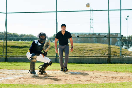 Come on, I got you. Full length shot of a young baseball player waiting to catch a ball during a...
