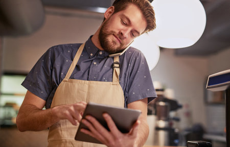 Make sure your online presence is all it can be. Shot of a young man using a digital tablet while...