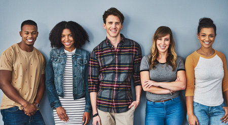 Good friends stand together. Studio portrait of a diverse group of young people standing together...