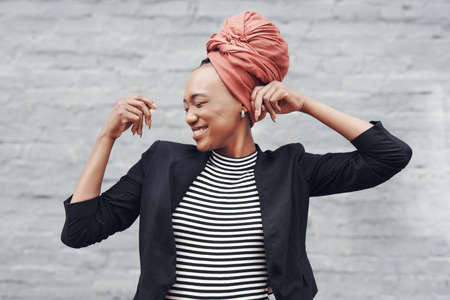 Expressing her freedom. Cropped shot of an attractive young businesswoman looking carefree against a...
