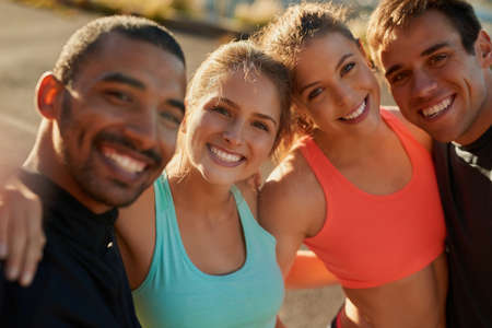 Theyre a group of fitness-minded friends. Portrait of a group of friends out for a run.の写真素材