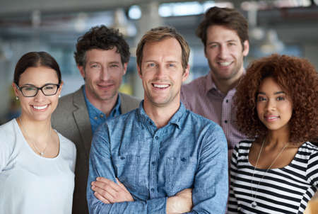 Diverse minds for strong business. A diverse group of creative professionals looking positively at...