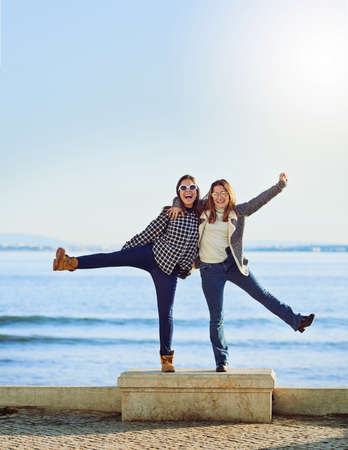 The sea and my bestie. Full length portrait of two attractive young women spending a day by the ocean.の写真素材
