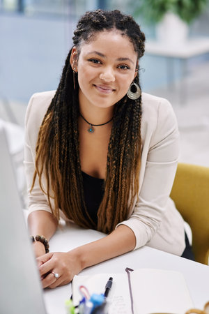 This is just the beginning. High angle portrait of an attractive young businesswoman sitting at her...