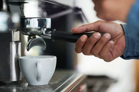 The heart of good coffee lies in its preperation. Cropped shot of a barista making a cup of coffee.の写真素材