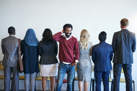 It pays to have a different perspective. Portrait of a happy job applicant standing in line with a...