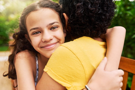 I love my mom. Cropped portrait of an adorable young girl and her mother embracing in the park.の写真素材