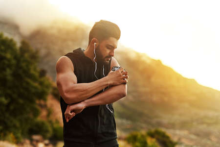 The right track can change everything. Shot of a young man exercising outdoors.の写真素材