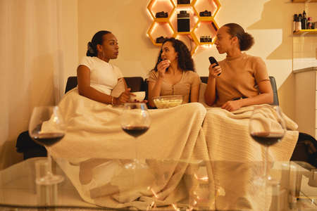 Tell me about it all. Shot of a group of young friends relaxing and having a chat on the couch.