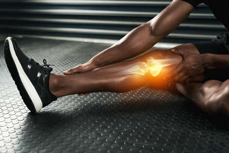 When in doubt, stretch it out. Studio shot of an unrecognizable man examining a knee injury during...