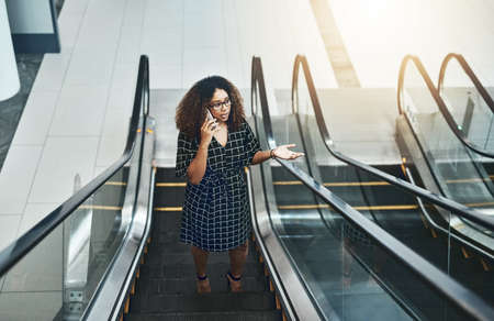 Making business plans on the move. High angle shot of an attractive young businesswoman taking a...