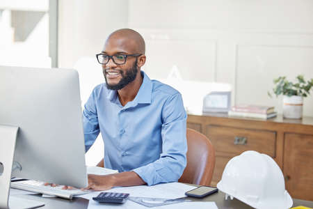 If your inbox is full of satisfied clients, youre doing good. Shot of a businessman using his...