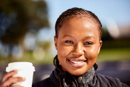 A much needed caffeine kick. Shot of a young woman enjoying a cup of coffee.