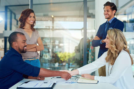 Lets make this partnership a successful one. Shot of a group of businesspeople having a meeting in a...