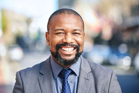 If you have a dream, go out and catch it. Shot of a businessman wearing a suit while out in the city.の写真素材