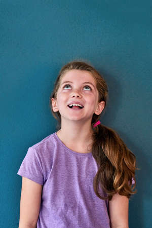 Being a kid is all fun all the time. Studio shot of an adorable little girl looking amazed and...