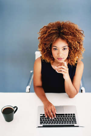On the cutting edge of online marketing. Portrait of a young businesswoman working on a laptop at...