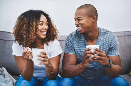 Theyve found true happiness in each other. Shot of a young couple relaxing together at home.の写真素材