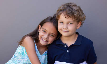 Well be best friends for life. Shot of a young boy and girl sitting together against a grey...