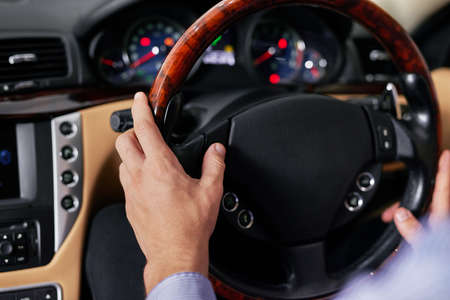 Take to the road. Closeup shot of a businessman driving a car.