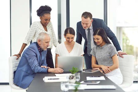 Talking business. Cropped shot of a group of businesspeople having a meeting together in an office.
