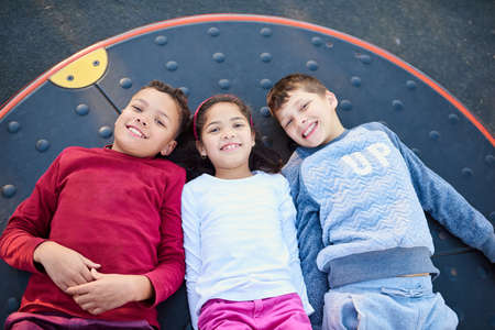 Fun times at our favourite place. Portrait of three young siblings playing together at the park.