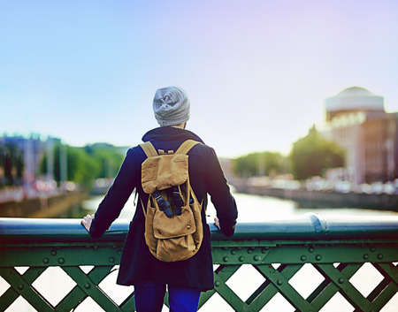 The city puts everything into perspective. Rearview shot of a young man looking at the city view...