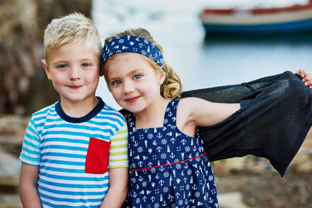 Double the cuteness. Portrait of a cute little brother and sister posing together on a day out.