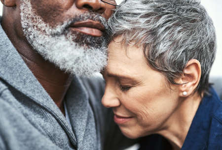 Her safest place is in his arms. Cropped shot of an affectionate senior couple relaxing on the sofa...