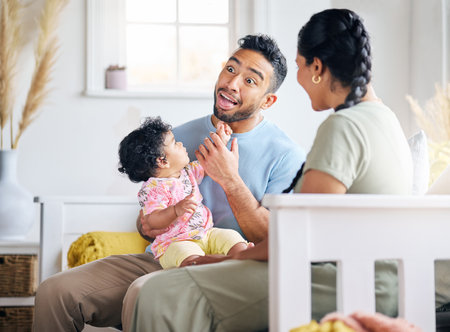 She loves dads silly faces. Shot of a young family spending time together at home.