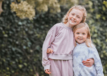 Dont believe in angels You havent seen my sister. Shot of two adorable little girls having fun in a garden.の写真素材