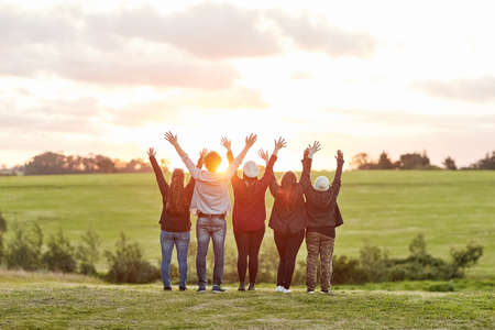 Living in the moment. Rearview shot of a group of friends admiring the view together on a weekend getaway.の写真素材