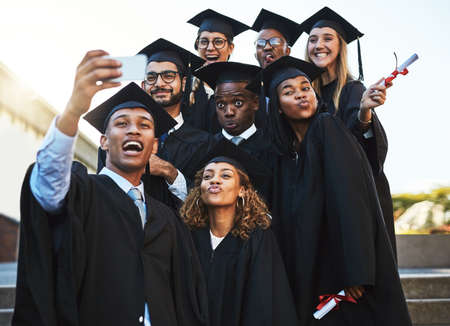 Well never forget this day. Shot of a group of students taking a selfie on graduation day.