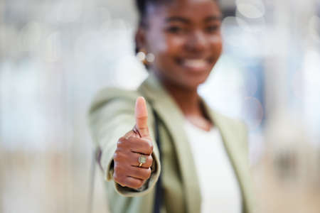 Together well take over the world. Shot of a young woman giving the thumbs up while shopping.