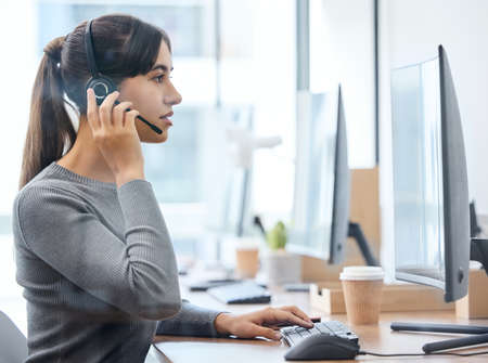 With hard work and effort, you can achieve anything. Shot of a young businesswoman working on a computer in an office.の写真素材