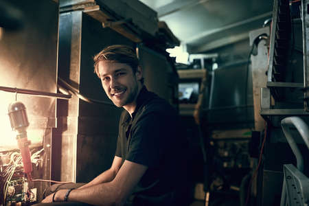 If its broke, Ill fix it. Cropped portrait of a handsome young man making some repairs indoors.