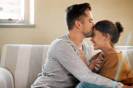 You came and gave my life new meaning. Cropped shot of a young couple relaxing on the sofa at home.