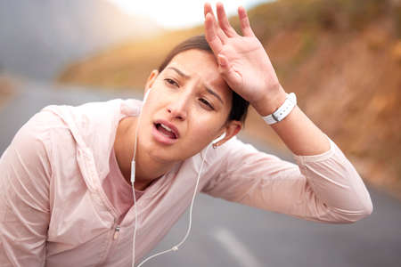 If youre not breaking a sweat, youre doing it wrong. Shot of a young woman taking a break while...