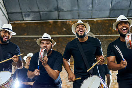 Their beats make you wanna get up and dance. Shot of a group of musical performers playing together...