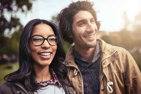 We spend time everyday together. Shot of a cheerful young couple standing next to each other and...