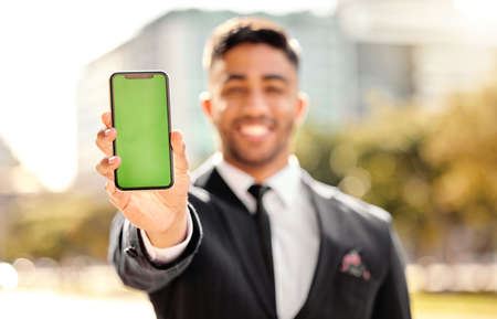 You have to see this. Shot of a businessman holding his smartphone.の写真素材