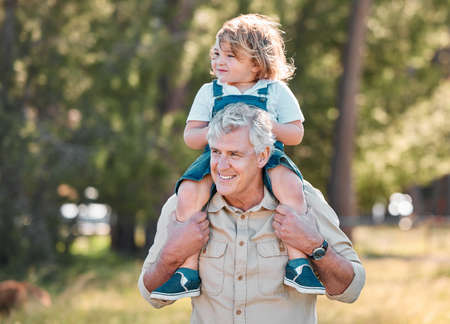 This is where I raised my son, on my shoulders. Shot of a senior man carrying his grandson on his...