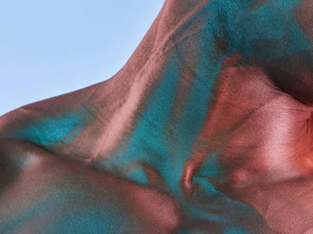 Even tough people have weak spots. Shot of a muscular man posing against a studio background.の写真素材