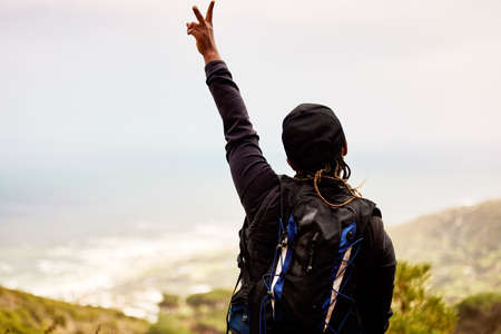 Peace to all the negativity. Shot of an unrecognizable woman enjoying a day in nature.の写真素材