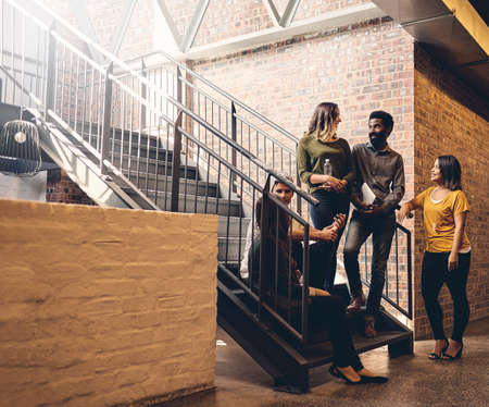 Theyre a tightly knit team. Full length shot of a group of young designers gathered in a stairwell...