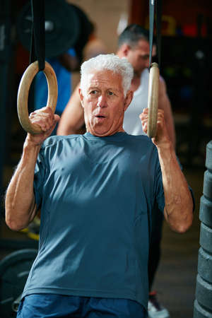 Hes still as fit as a fiddle. Cropped shot of a senior man working out in the gym.