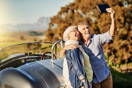 Taking a selfie for the grandkids. Shot of a senior couple posing for a selfie while out on a...