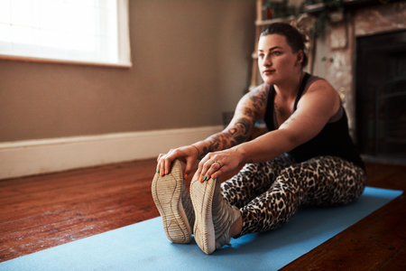 Take the time to improve on your health. Shot of a young woman exercising at home.